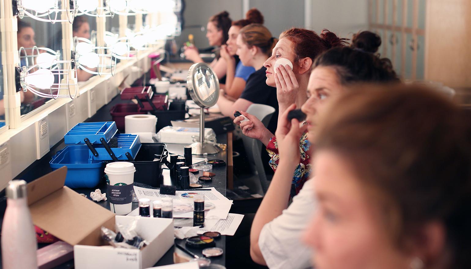 Students doing stage makeup